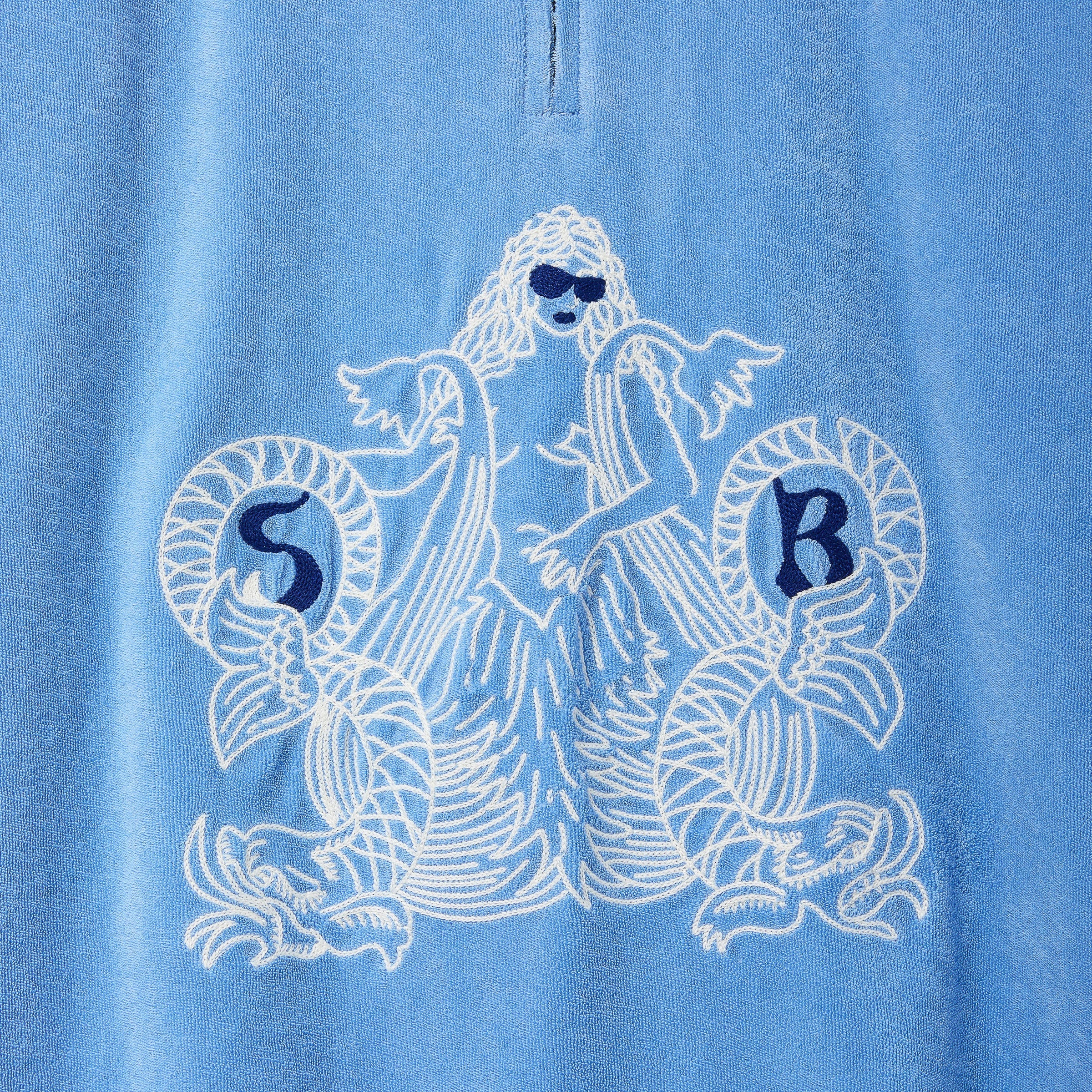 Blue shirt with white mermaid design and 'SR' initials on a blue background