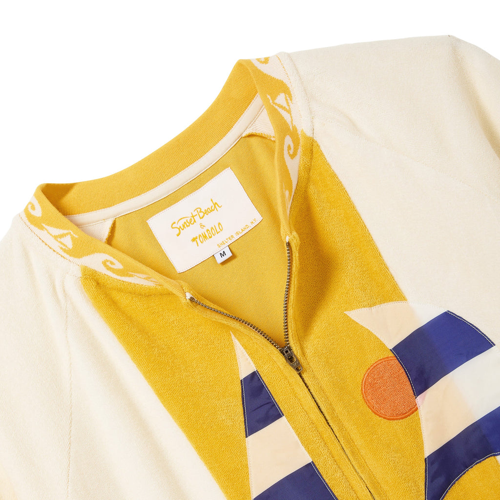 Close-up of a colorful cabana shirt with a brand label on a white background