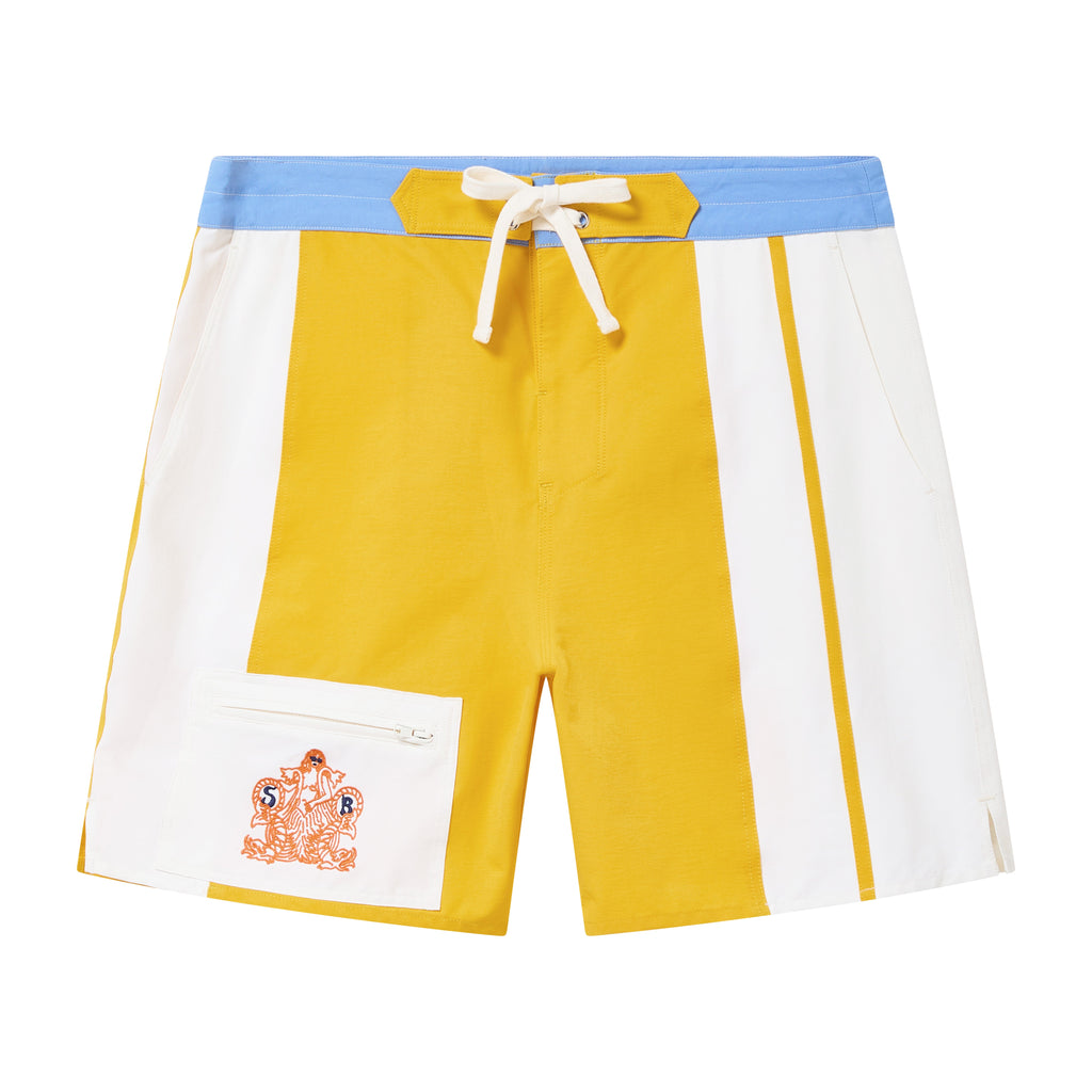 Color-blocked shorts with yellow, white, and blue sections on a white background