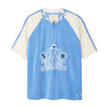 A light blue and cream raglan-style short-sleeve top with a half-zip neckline, featuring a white graphic print of a mermaid and the letters 'S B' on the front, set against a plain white background.