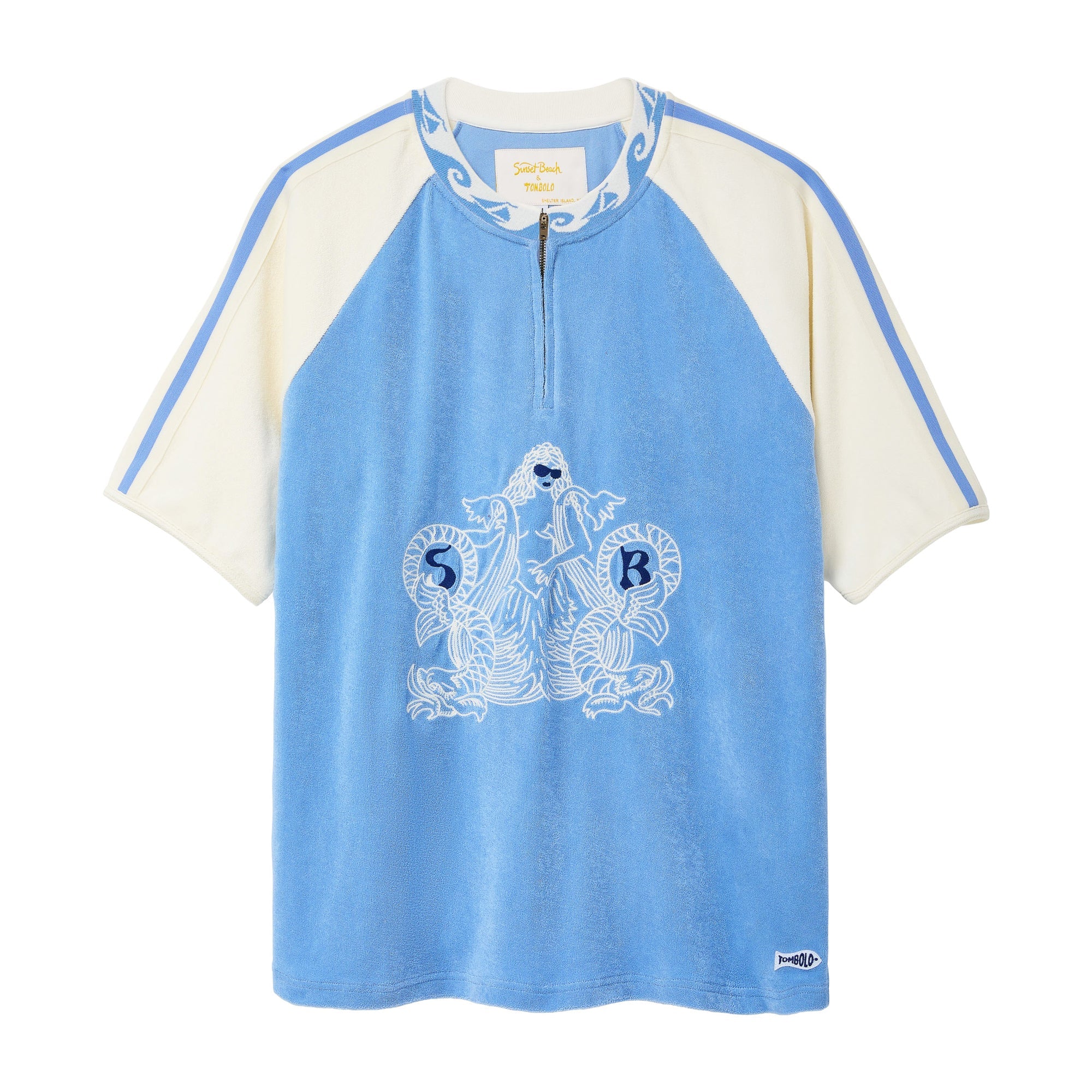 A light blue and cream raglan-style short-sleeve top with a half-zip neckline, featuring a white graphic print of a mermaid and the letters 'S B' on the front, set against a plain white background.